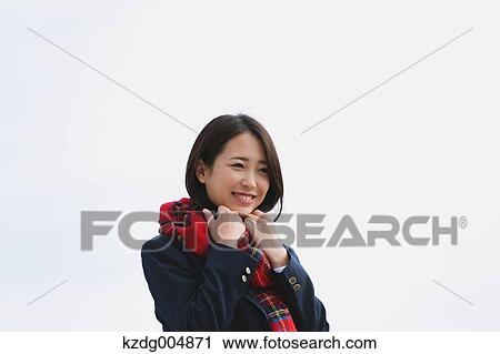 Japanese high-school student with scarf against blue sky View Large Photo Image Stock Image - Japanese high-school student with scarf against blue sky. Fotosearch