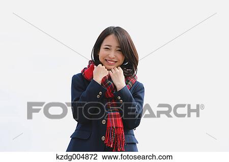 Stock Image - Japanese high-school student with scarf against blue sky. Fotosearch