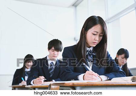 Stock Image - Japanese high-school students during a lesson. Fotosearch