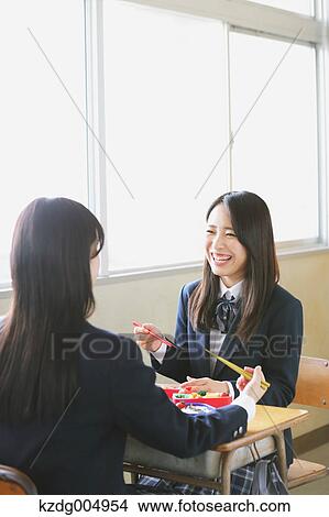 Picture - Japanese high-school students having bento in classroom. Fotosearch