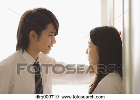 Stock Photo - Japanese high-school students in a romantic moment in the school corridor. Fotosearch