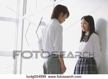 Stock Photo - Japanese high-school students in a romantic moment in the school corridor. Fotosearch