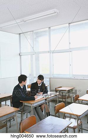 Stock Image - Japanese high-school students in empty classroom. Fotosearch