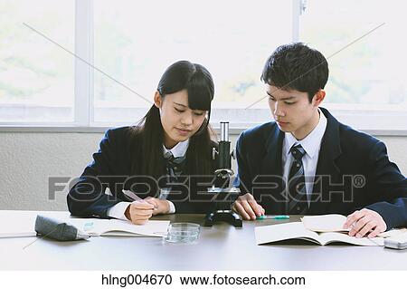 Stock Image - Japanese high-school students in empty classroom. Fotosearch