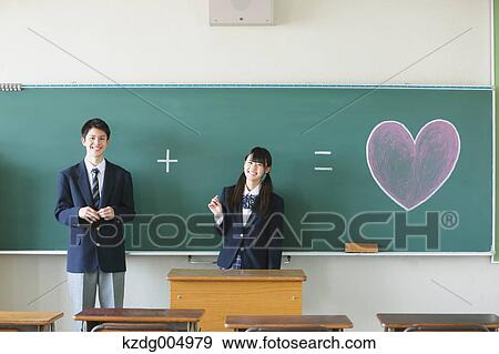 Stock Photo - Japanese high-school students in front of classroom blackboard. Fotosearch