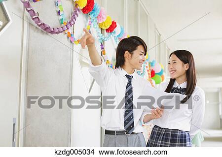 Picture - Japanese high-school students in decorated school corridor. Fotosearch