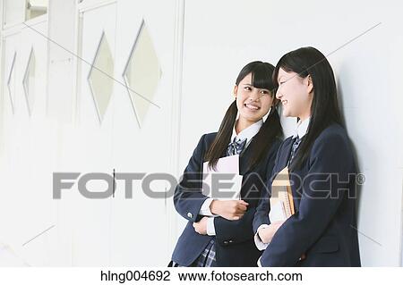 Stock Image - Japanese high-school students in school corridor. Fotosearch
