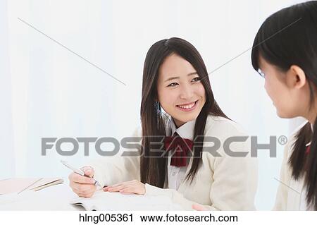 Stock Image - Japanese High-school students in uniform studying together. Fotosearch