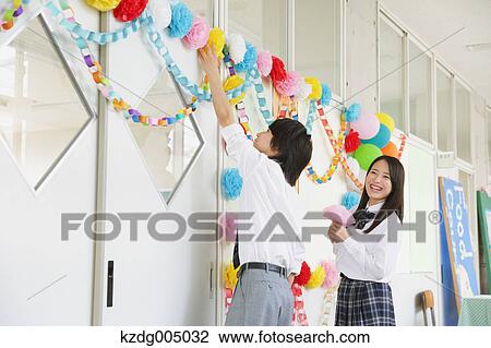 Stock Image - Japanese high-school students in decorated school corridor. Fotosearch