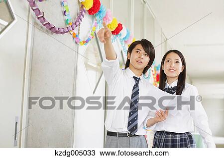 Stock Image - Japanese high-school students in decorated school corridor. Fotosearch