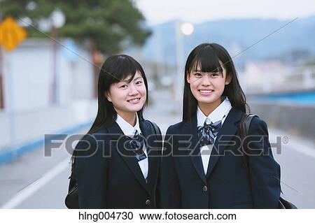 Stock Image - Japanese high-school students outside the school. Fotosearch
