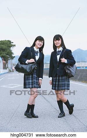 Stock Image - Japanese high-school students outside the school. Fotosearch
