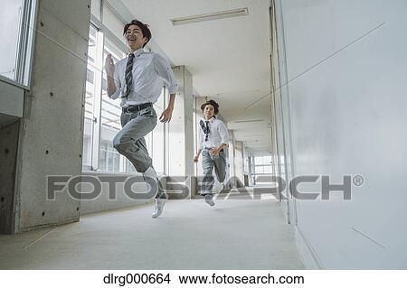 Japanese high-school students running in school corridor View Large Photo Image Picture - Japanese high-school students running in school corridor. Fotosearch