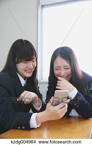 Japanese high-school students with smartphone in classroom View Large Photo Image Picture - Japanese high-school students with smartphone in classroom. Fotosearch