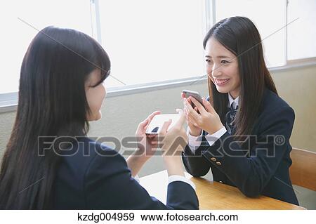 Stock Photo - Japanese high-school students with smartphone in classroom. Fotosearch