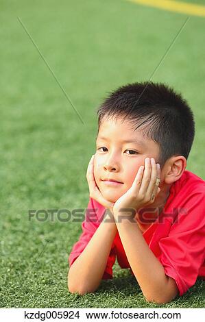 Picture - Japanese kid at soccer field. Fotosearch