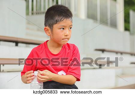 Stock Image - Japanese kid at soccer field. Fotosearch