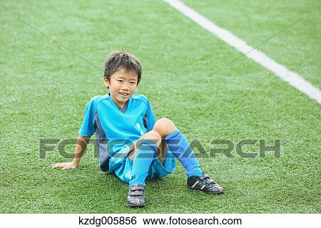 Stock Photograph - Japanese kid at soccer field. Fotosearch