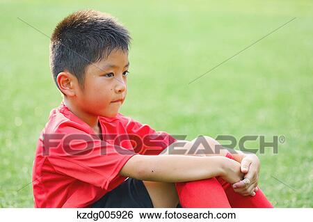 Stock Photograph - Japanese kid at soccer field. Fotosearch