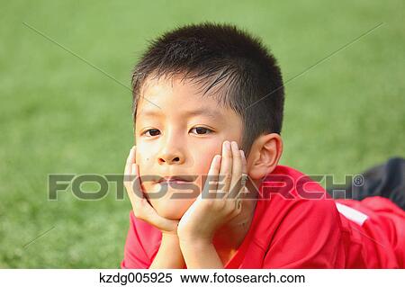 Stock Photography - Japanese kid at soccer field. Fotosearch