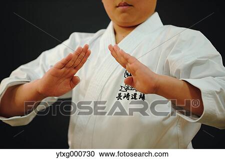 Stock Image - Japanese kid in karate uniform on black background. Fotosearch