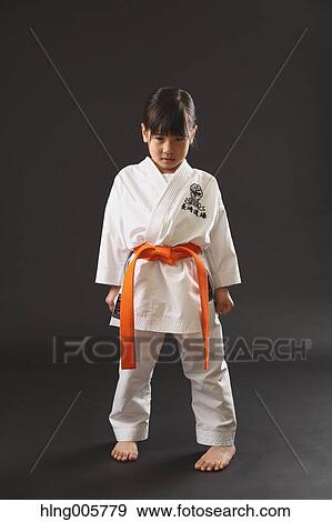 Stock Photo - Japanese kid in karate uniform on black background. Fotosearch