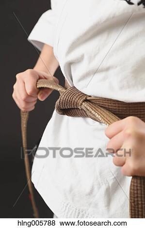 Stock Photo - Japanese kid in karate uniform on black background. Fotosearch