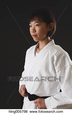 Stock Photo - Japanese kid in karate uniform on black background. Fotosearch