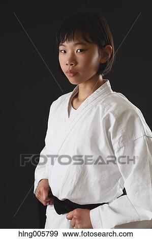 Stock Photo - Japanese kid in karate uniform on black background. Fotosearch