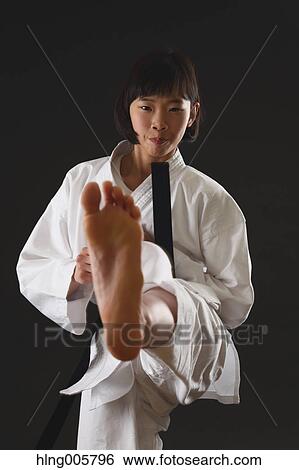 Stock Photograph - Japanese kid in karate uniform on black background. Fotosearch