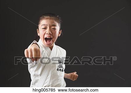 Stock Photography - Japanese kid in karate uniform on black background. Fotosearch