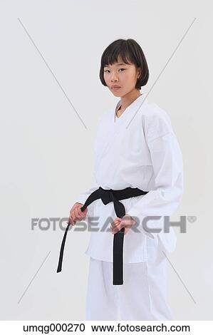 Stock Image - Japanese kid in karate uniform on white background. Fotosearch