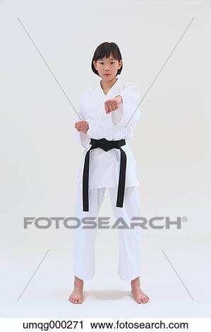 Stock Image - Japanese kid in karate uniform on white background. Fotosearch