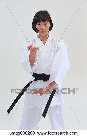 Stock Image - Japanese kid in karate uniform on white background. Fotosearch