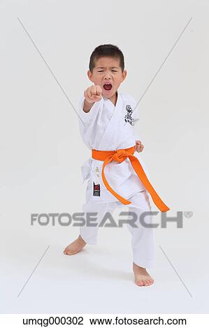 Stock Image - Japanese kid in karate uniform on white background. Fotosearch