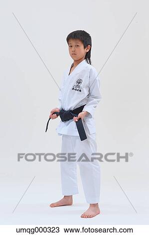 Stock Image - Japanese kid in karate uniform on white background. Fotosearch