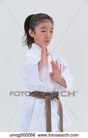 Stock Photo - Japanese kid in karate uniform on white background. Fotosearch