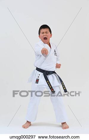 Stock Photo - Japanese kid in karate uniform on white background. Fotosearch