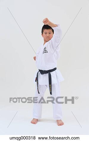 Stock Photo - Japanese kid in karate uniform on white background. Fotosearch