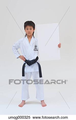 Stock Photography - Japanese kid in karate uniform on white background. Fotosearch