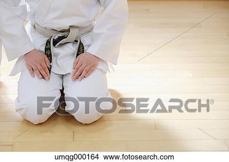Picture - Japanese kid in karate uniform training. Fotosearch