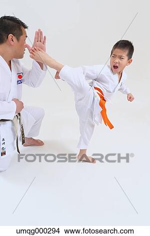 Japanese kid in karate uniform training with teacher on white background View Large Photo Image Picture - Japanese kid in karate uniform training with teacher on white background. Fotosearch