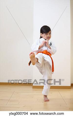 Picture - Japanese kid in karate uniform training. Fotosearch