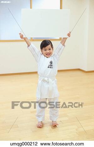 Stock Image - Japanese kid in karate uniform training. Fotosearch