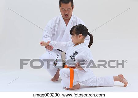 Japanese kid in karate uniform training with teacher on white background View Large Photo Image Stock Image - Japanese kid in karate uniform training with teacher on white background. Fotosearch