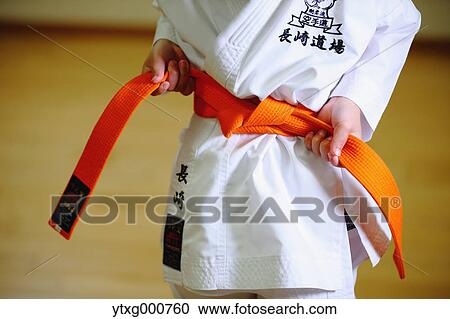 Stock Image - Japanese kid in karate uniform training. Fotosearch