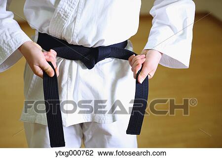 Stock Image - Japanese kid in karate uniform training. Fotosearch