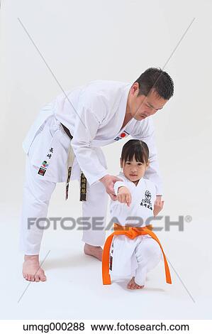 Japanese kid in karate uniform training with teacher on white background View Large Photo Image Stock Photo - Japanese kid in karate uniform training with teacher on white background. Fotosearch