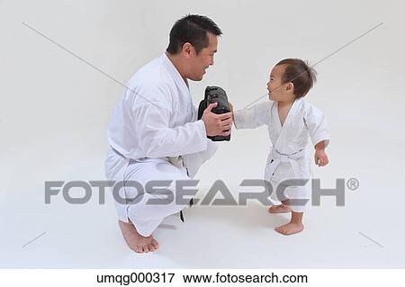 Japanese kid in karate uniform training with teacher on white background View Large Photo Image Stock Photo - Japanese kid in karate uniform training with teacher on white background. Fotosearch