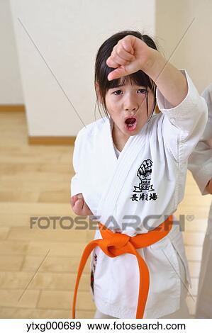 Stock Photo - Japanese kid in karate uniform training. Fotosearch